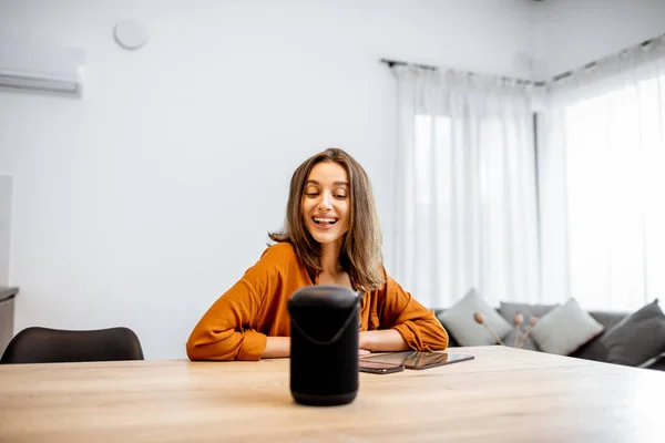 Woman controlling home devices with a voice commands — Stok fotoğraf