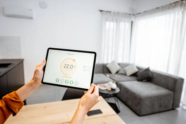 Controlling heating with a digital tablet at home — ストック写真