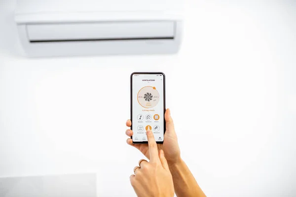 Controlling ventilation with a smart phone at home — Stock Fotó
