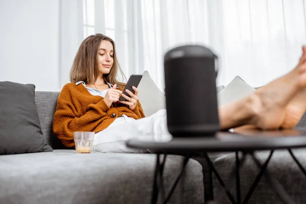 Woman controlling home devices with a voice commands — Stock fotografie