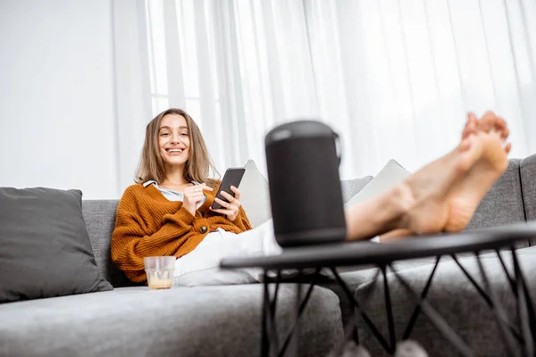 Woman controlling home devices with a voice commands