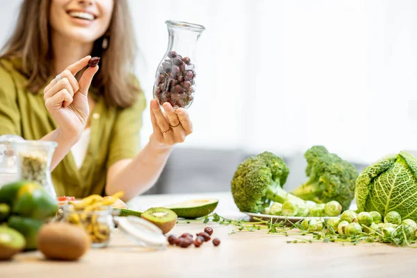 Young woman with fresh vegan food ingredients — Stockfoto