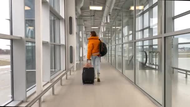 Woman walking at the airport terminal — Stockvideo