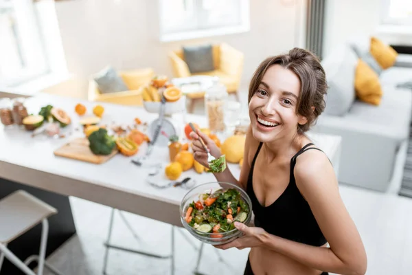 Sport kvinna med hälsosam mat hemma — Stockfoto