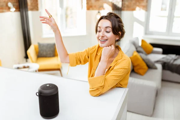 Woman controlling smart home devices with a voice commands — Stock Photo, Image