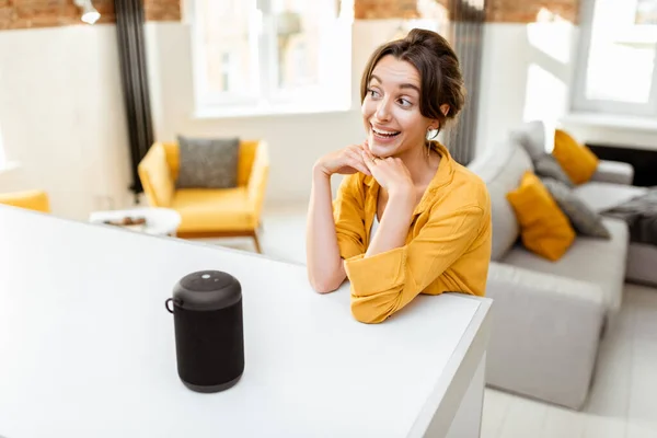 Woman controlling smart home devices with a voice commands — Stockfoto