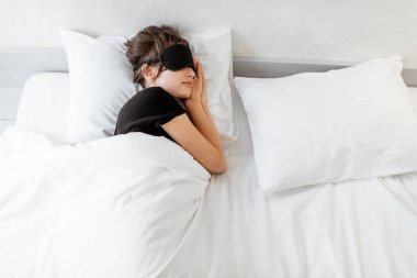 Woman sleeping with sleeping mask