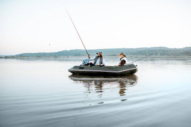 Grandfather with son fishing on the boat