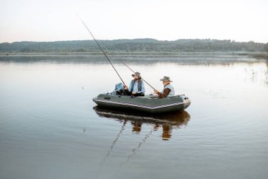 Grandfather with son fishing on the boat