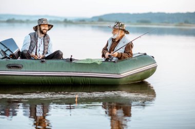 Grandfather with son fishing on the boat