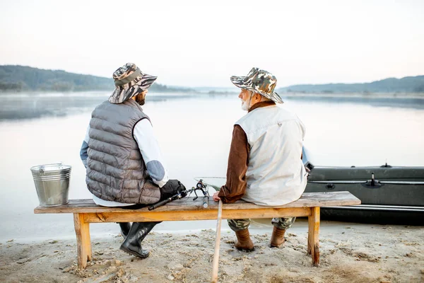 Grandfather with son fishing together — 图库照片