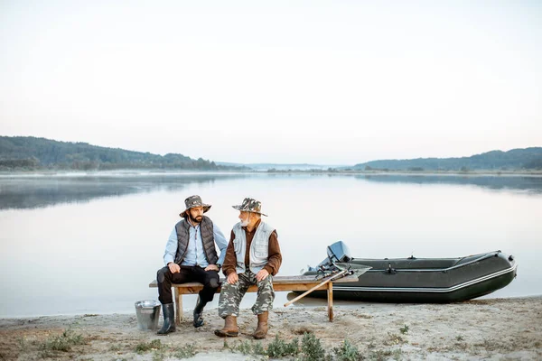 Grandfather with son fishing on the lake — Stok fotoğraf