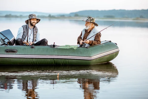 Grandfather with son fishing on the boat — Stockfoto