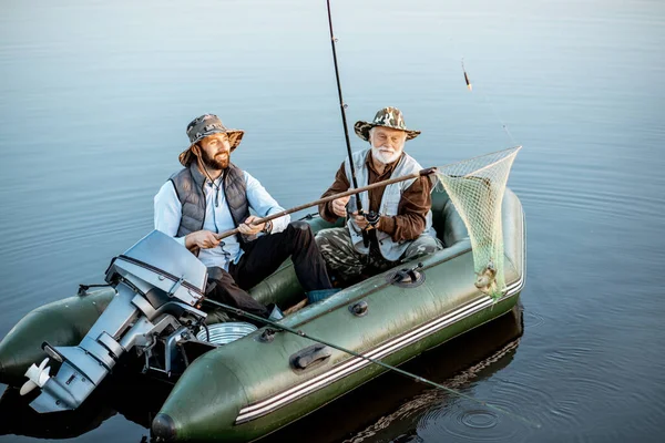 Grandfather with son fishing on the boat — 图库照片