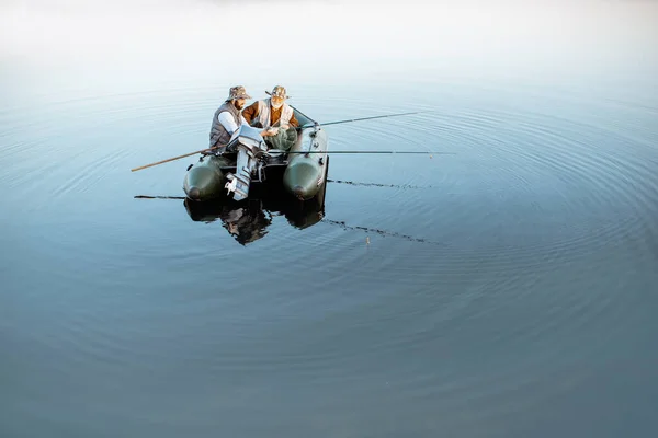 Avô com filho pescando no barco — Fotografia de Stock