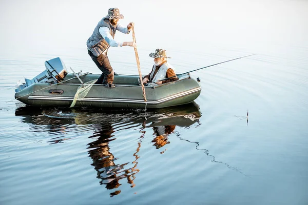 Grandfather with son fishing on the boat — Stockfoto