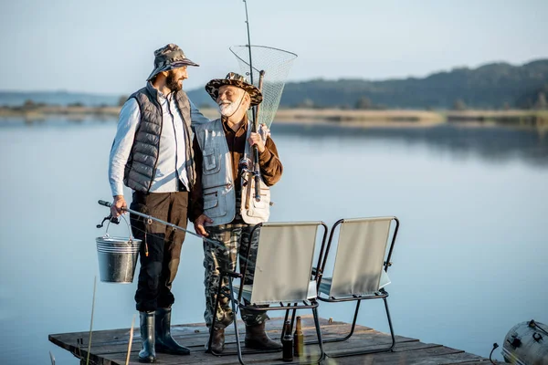 Grandfather with adult son fishing on the lake — Stockfoto