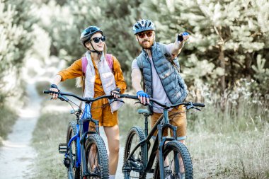 Ormanda bisikletle gezen bir çift.