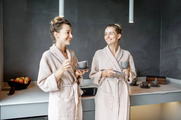 Vrouwen in badjassen ontspannen op de keuken — Stockfoto