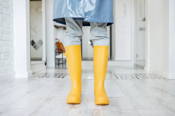 Woman in yellow rubber boots and raincoat indoors — Stock Photo, Image