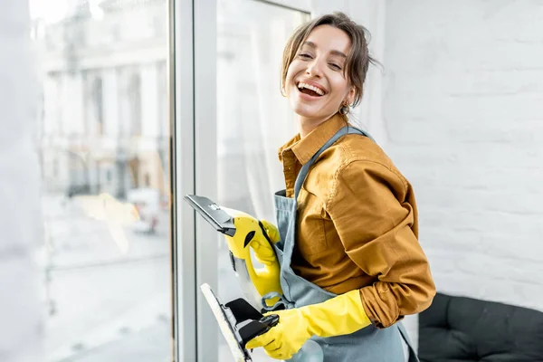 Housewife washing windows at home — Stock Photo, Image