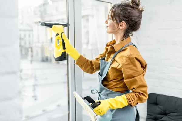 Huisvrouw wast ramen thuis — Stockfoto