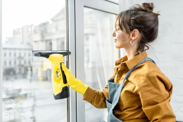 Housewife washing windows at home — Stock Photo, Image