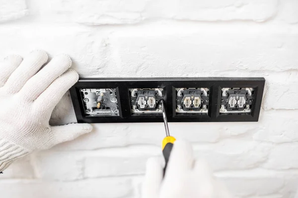 Electrician installing sockets and switches — Stock Photo, Image
