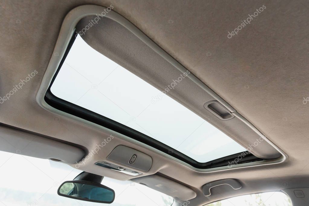 Automotive sunroof close up, white ceiling