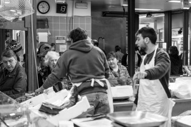FLORENCE, ITALY - 25, MARCH, 2016: Horizontal picture of unknown people buying italian products at Mercato Centrale Firenze, a touristic destionation of Florence, Italy clipart