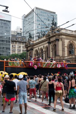 SAO PAULO, BRAZIL - 01 MARCH, 2020: Horizontal picture of showing movement of people dancing during carnaval in the streets of Sao Paulo, a popular brazilian traditional party.