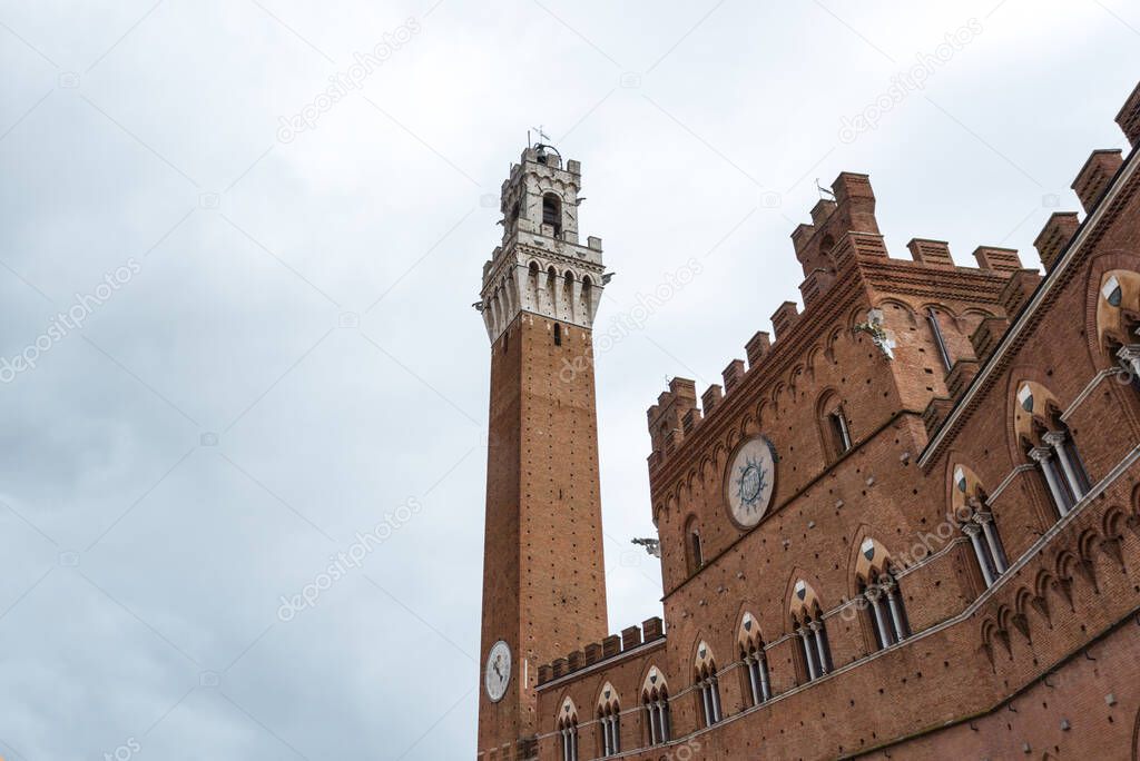 Wide angle picture of Torre del Mangia, an amazing old building located in the heart of Siena, Italy
