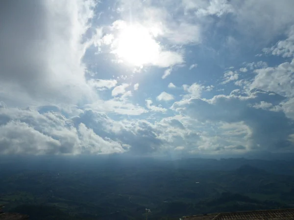 The image of sun rays, clouds and hills of San Marino
