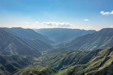 Beyaz sisle kaplı sisli dağ sırası ve muhteşem mavi gökyüzü görüntüsü tepenin güzel doğal manzarasını gösteriyor. Görüntü Latilum Peak Shillong Meghalaya Hindistan 'da çekilmiştir..