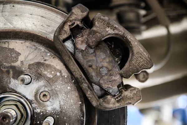 Old brake pad on the brake disc with a shallow depth of field — Stock Photo, Image