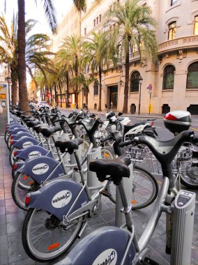 Valencia, Spain - February 10, 2020: bike sharing station in Valencia. Bicycle rental is sustainable and environmentally friendly. quarantine 2020 clipart
