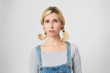 Genç sarışın kız portresi belirsiz, hissediyor tulum giyer. Erkek lise yeni kurallar hakkında karışık hissediyor. 