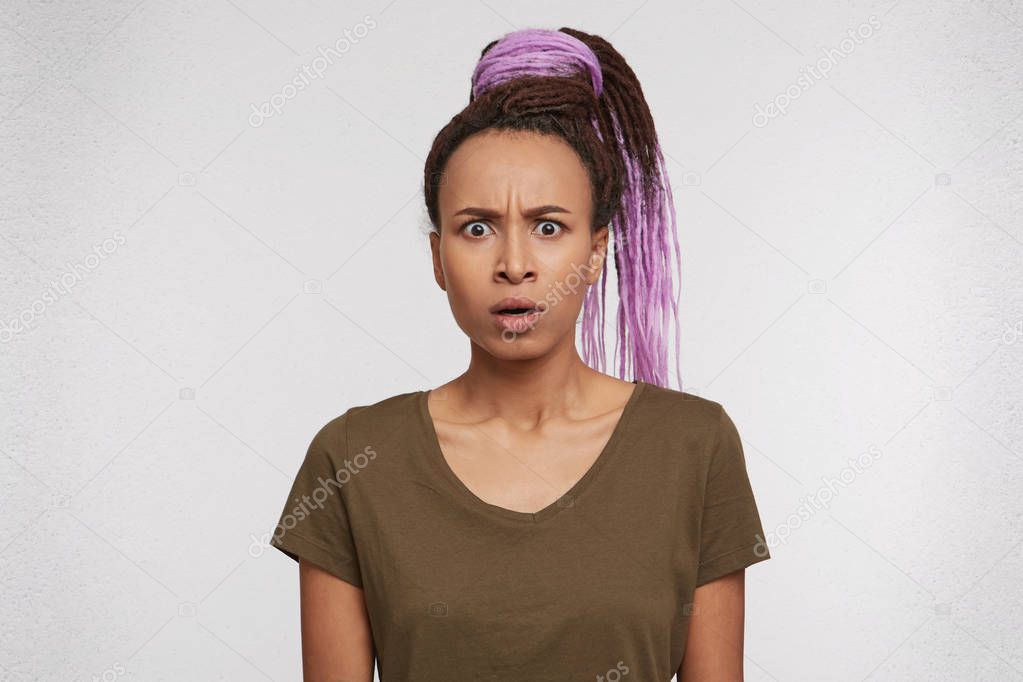 frightened and startled mixed race girl looks directly into camera with shocked expression, keep her mouth round