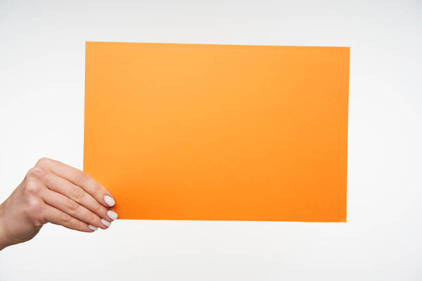 Photo of envelope A4 format with important documents being passed by elegant young woman's hand to someone, isolated against white background