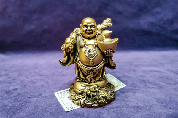 Chinese laughing god and american 100 dollars. Symbol of wealth and prosperity. Chinese New Year 2020 concept.