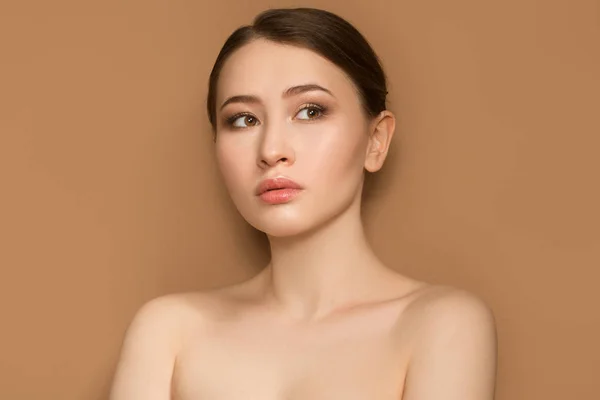 beautiful fashion woman. Portrait with natural make-up on a beig