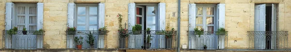 Panorama shot of rustic doors and balconies in France — Stock Photo, Image