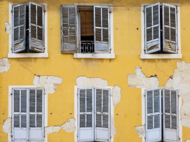 Texture of an old weathered building wall with peeling paint.