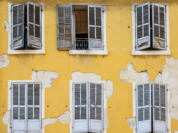 Texture of an old weathered building wall with peeling paint.