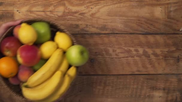 Hand placing fruit basket on table with message to remain calm — 图库视频影像