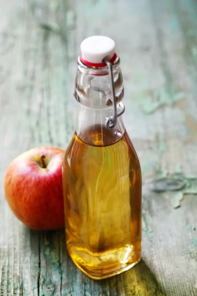 Apple Juice In A Bottle On A Green Wooden Background