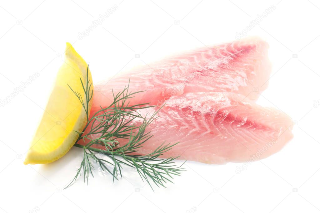 pink fish fillet with lemon and dill on white