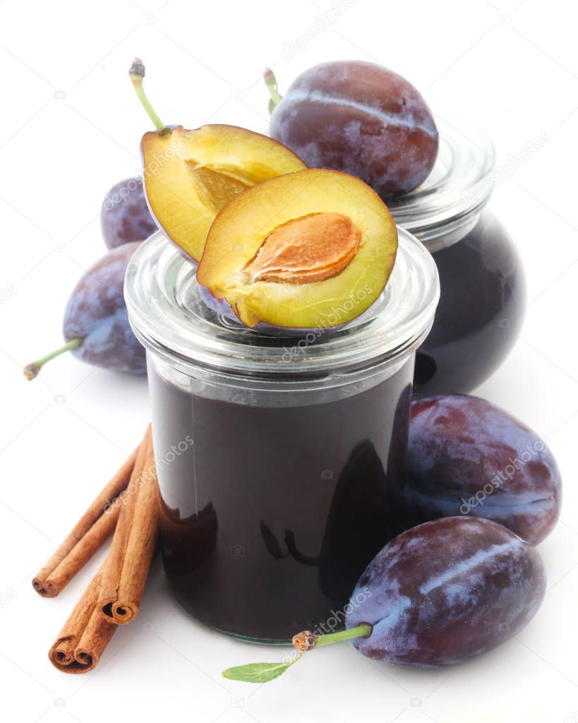 close-up shot of plum jam in jar on a white background