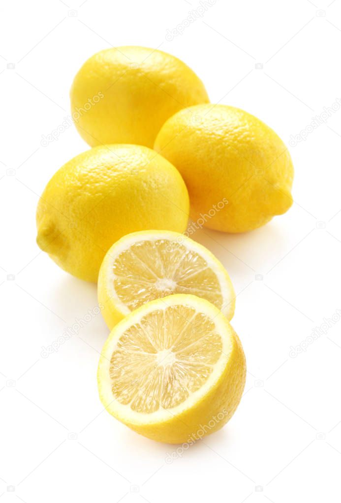 Whole And Halved Lemons Isolated On White
