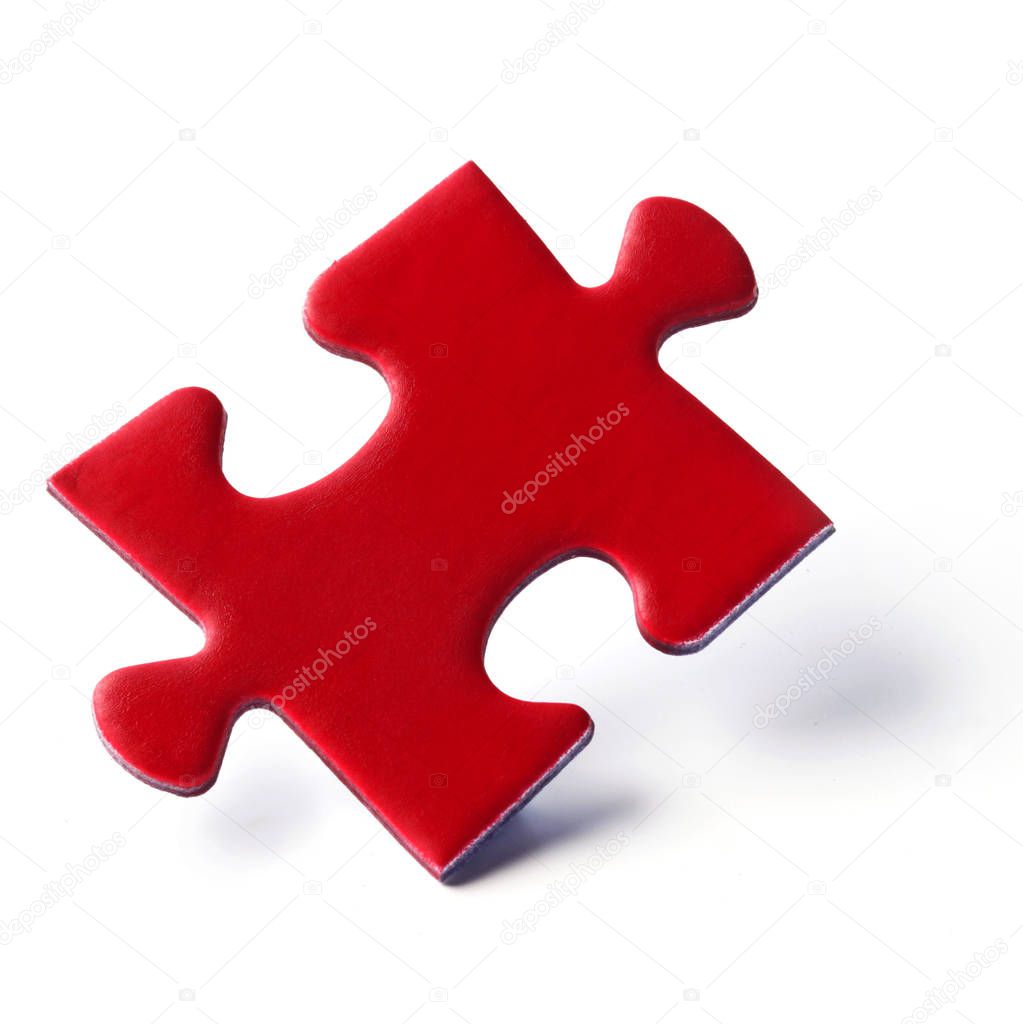 close-up shot of Red Jigsaw Puzzle Piece Isolated On White